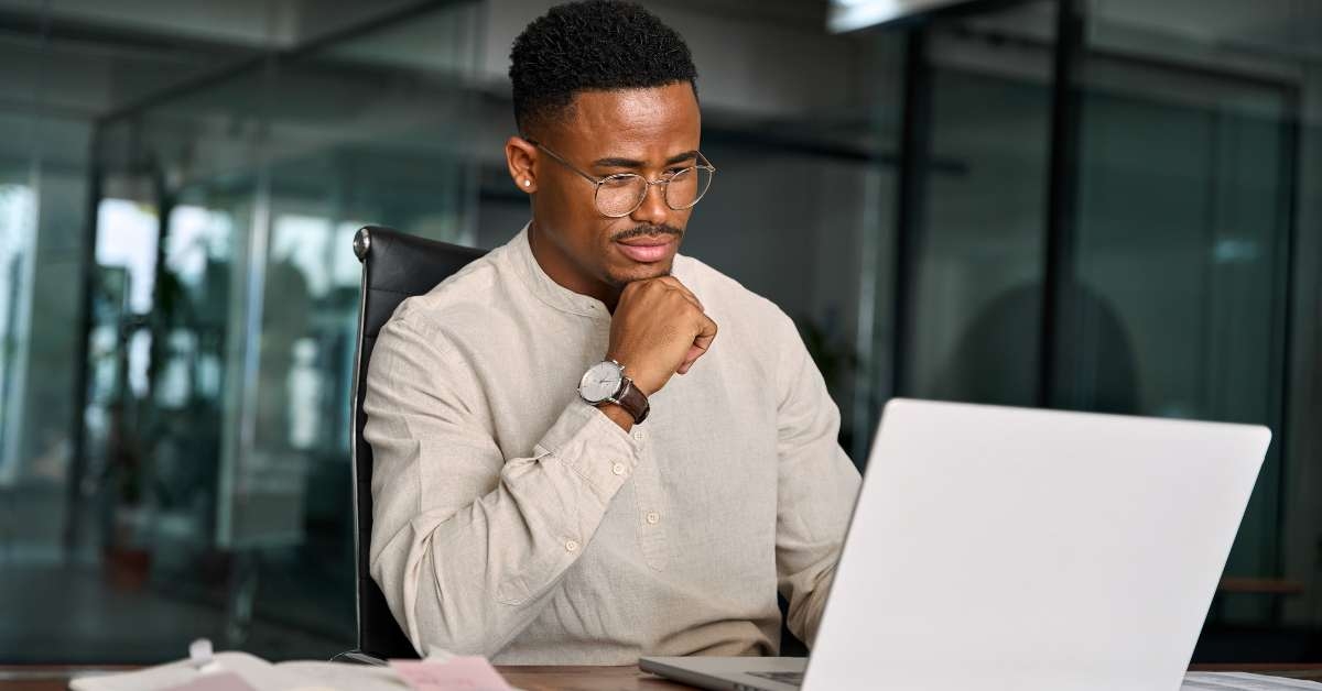young male businessman looking at computer