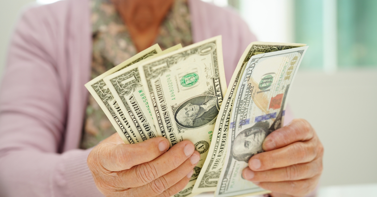 elderly woman counting money