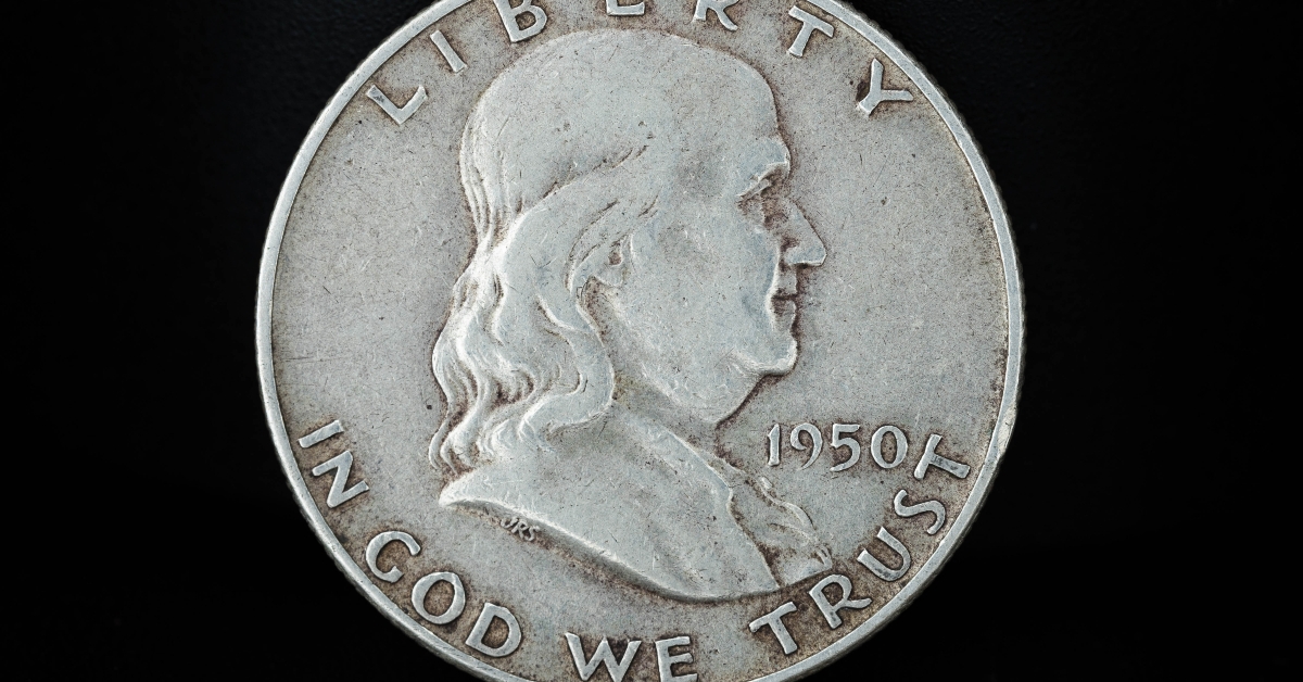 half dollar coin on black background