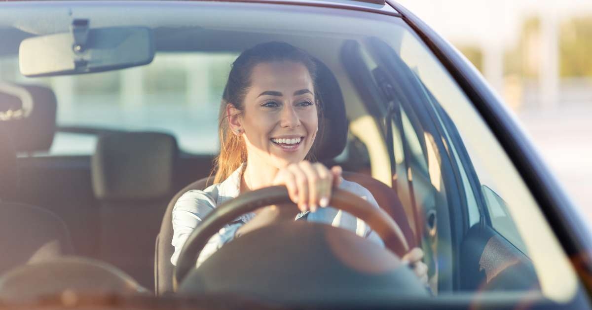 happy woman driving a car