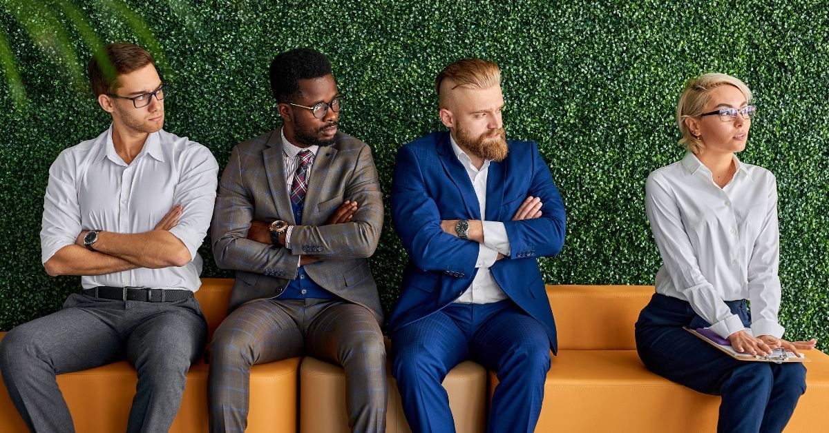 three male coworkers starting upset at new female employee