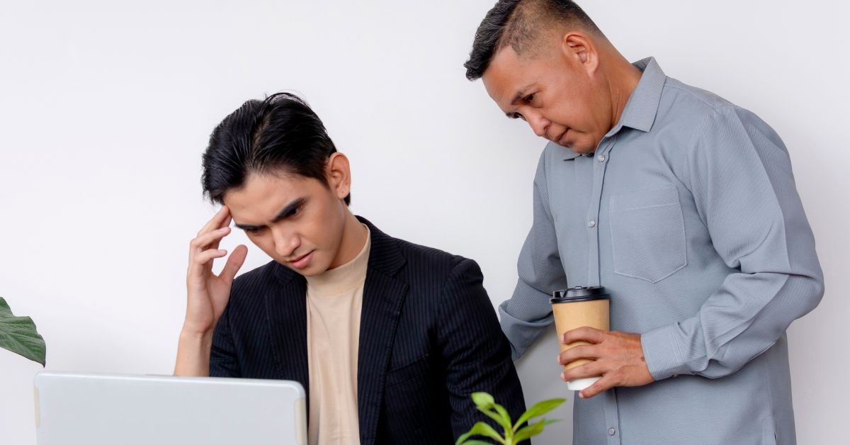 man micromanaging his coworker