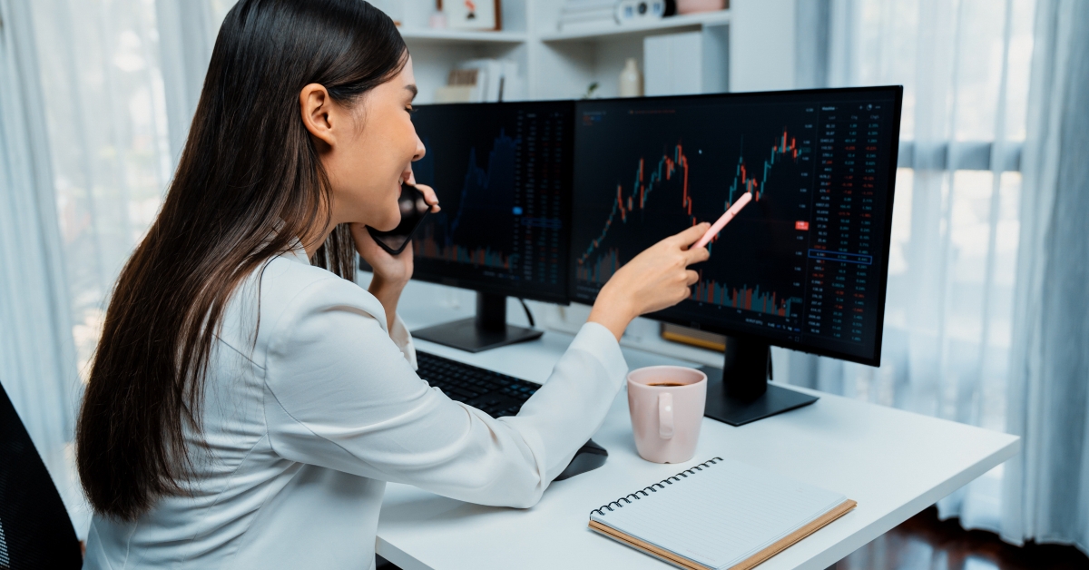 Asian businesswoman calling to broker pointing with pen
