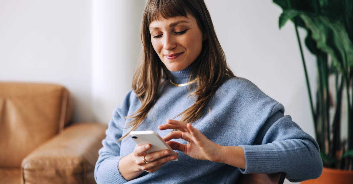 Businesswoman using a mobile phone in an office lobby