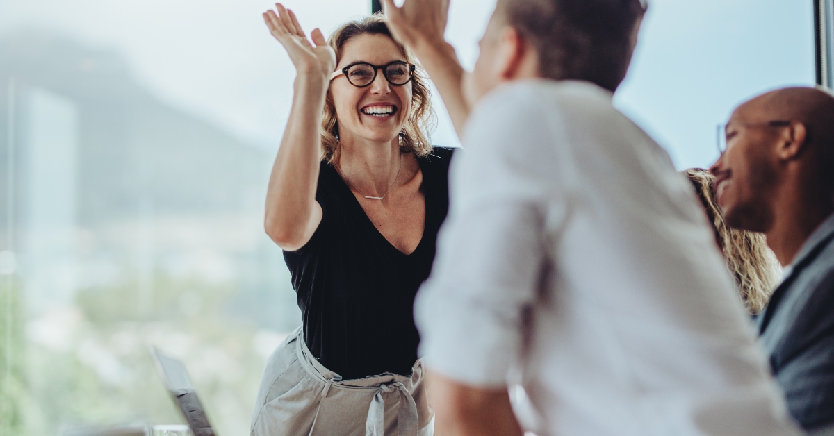 businesswoman giving a high five to a colleague