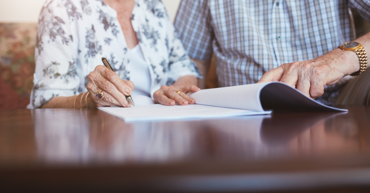 senior woman signing documents