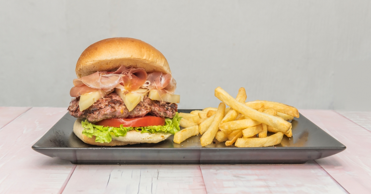 fresh hamburger with fries on tray