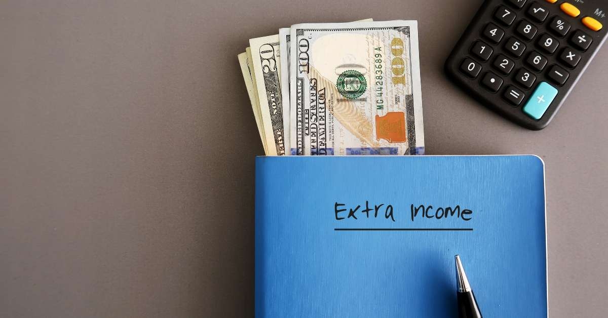 dollar money pen calculator on a blue notebook