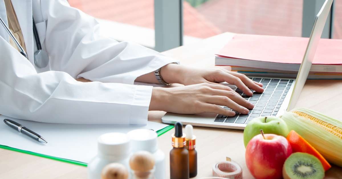 female nutritionist doctor work on laptop