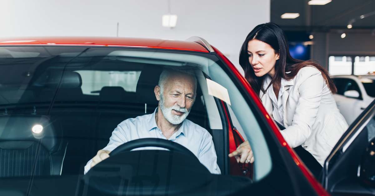 man choosing a new car at car showroom