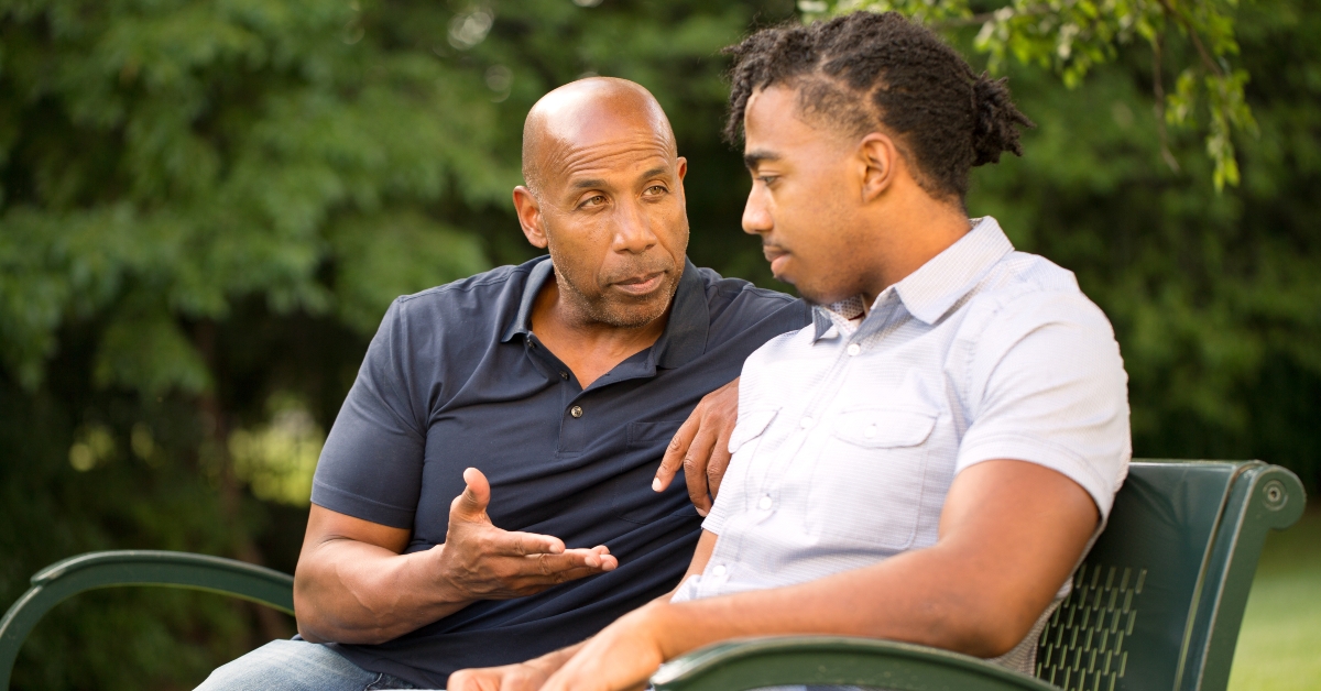 mature man giving advice to a younger man
