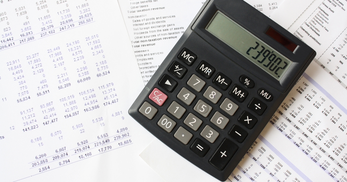 calculator placed on top of financial spreadsheets