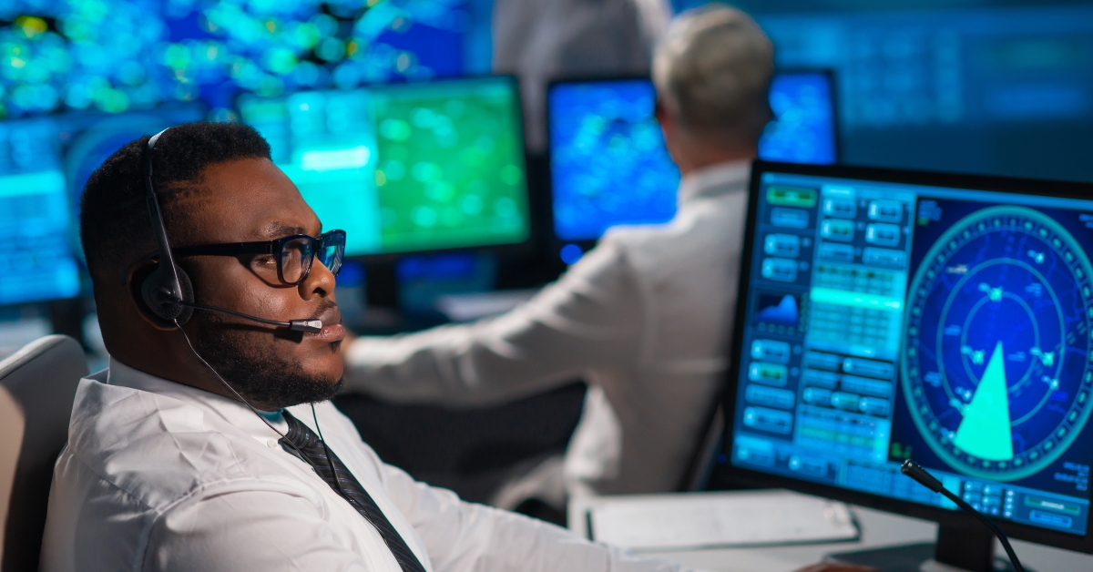 Diverse team of aircraft control officers works using radar