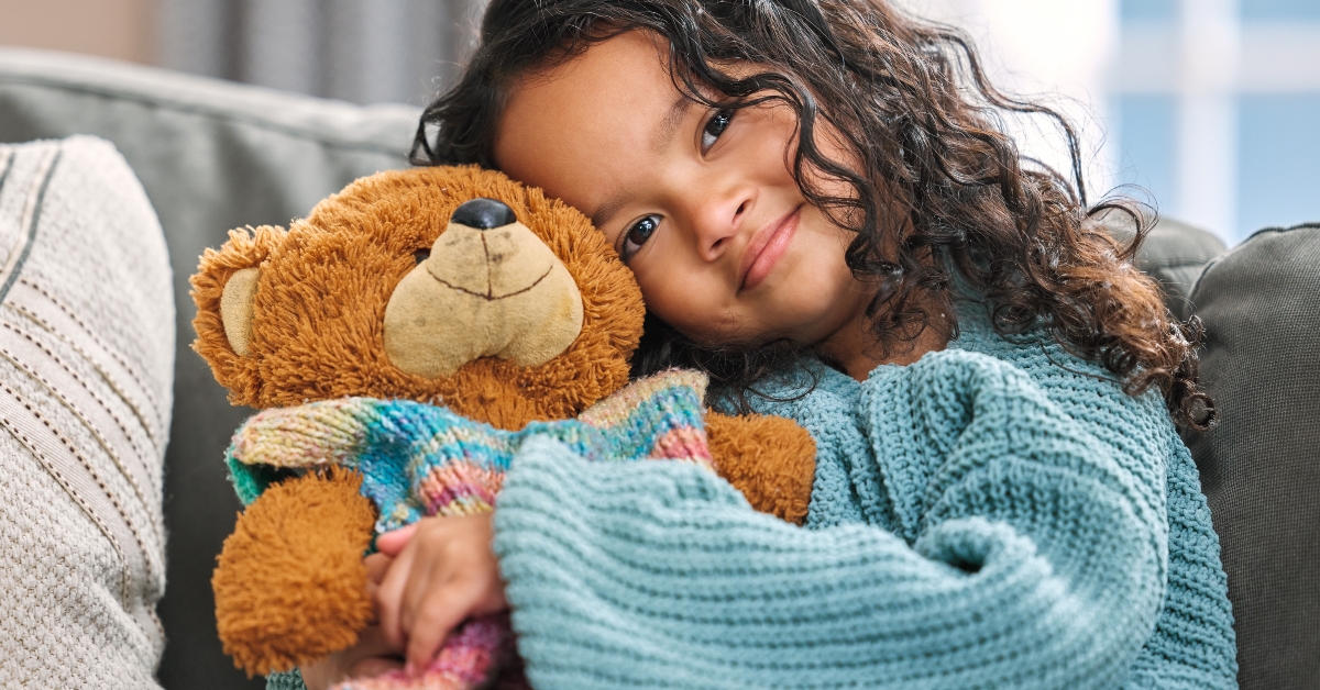 cute little girl hugged her teddy bear
