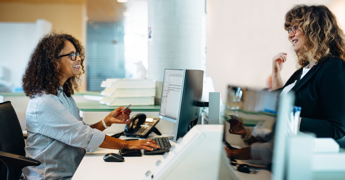 Friendly receptionist helping a woman
