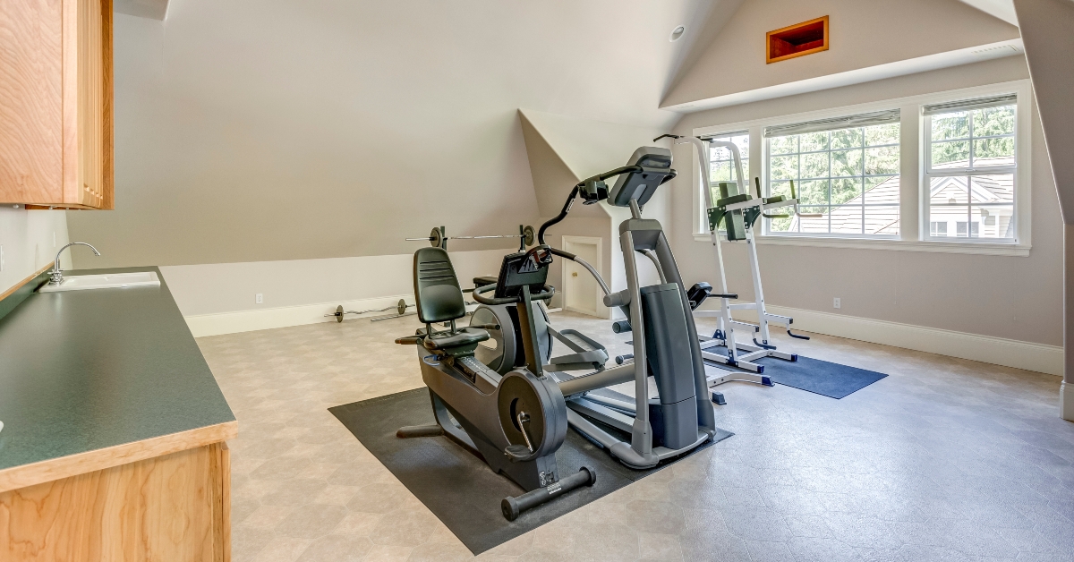 Well appointed home gym with vaulted ceiling