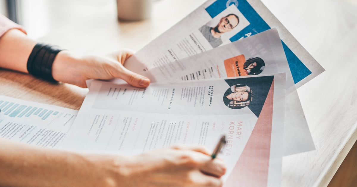 manager looking at many different cv resume