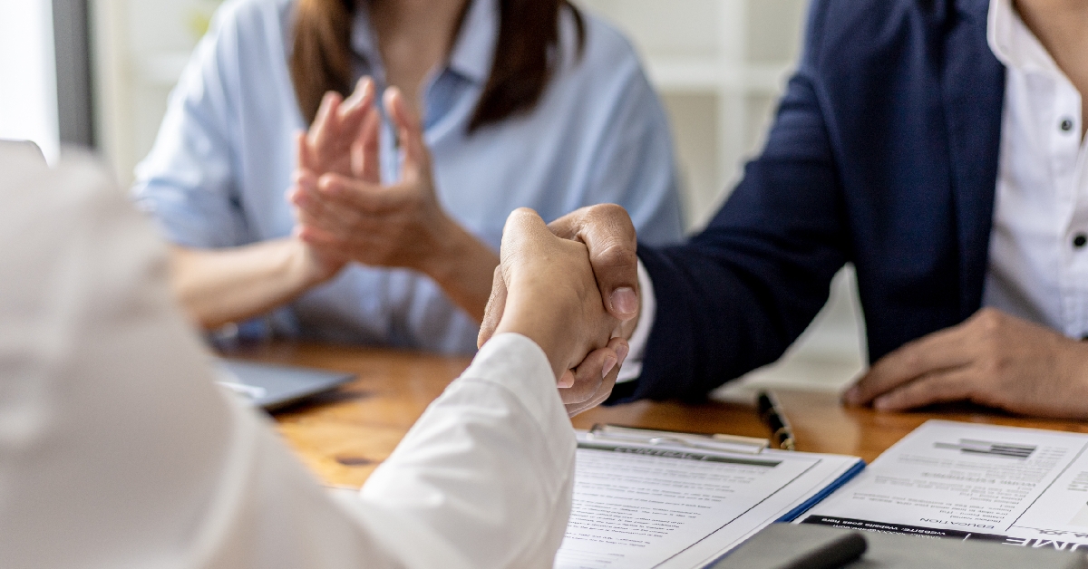managers and job applicants shake hands