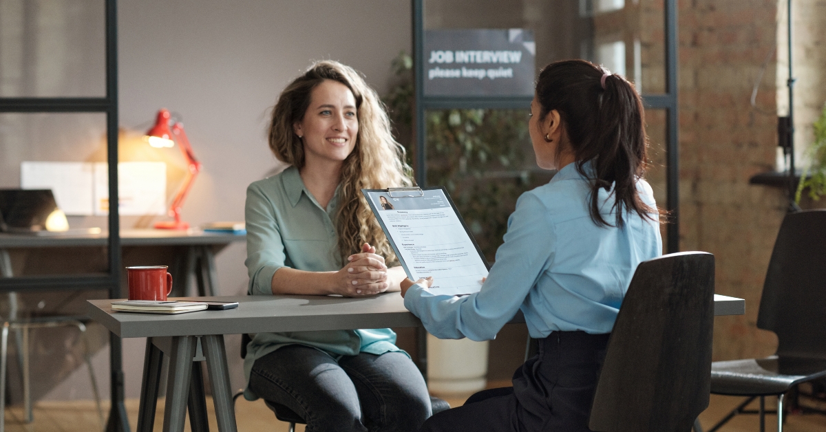 woman presenting her resume to female director