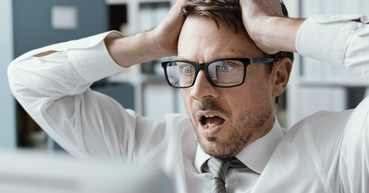 Panicking businessman receiving bad news