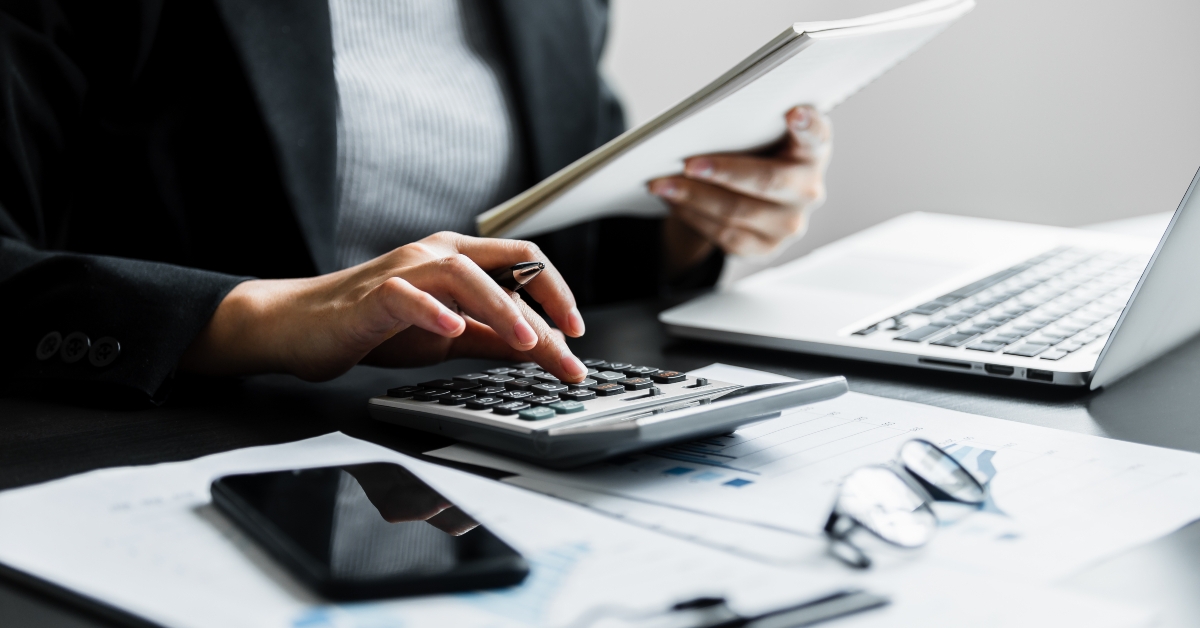 businesswomen using calculator while working