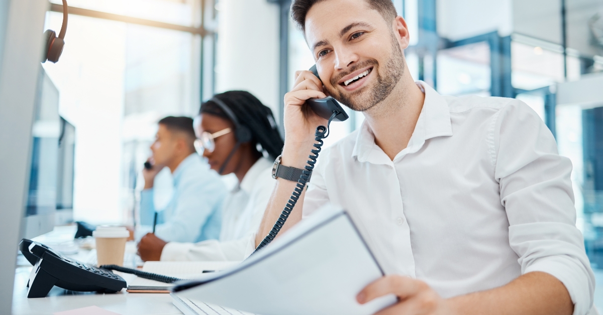 customer service worker smiling while talking on telephone