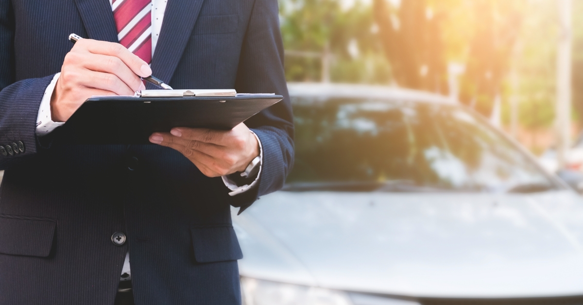 insurance expert employee working with a car outdoor