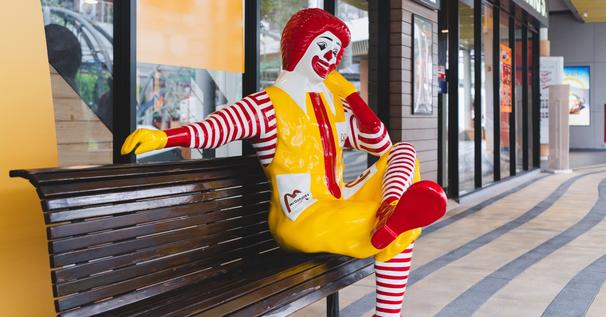 ronald-mcdonald sitting on bench