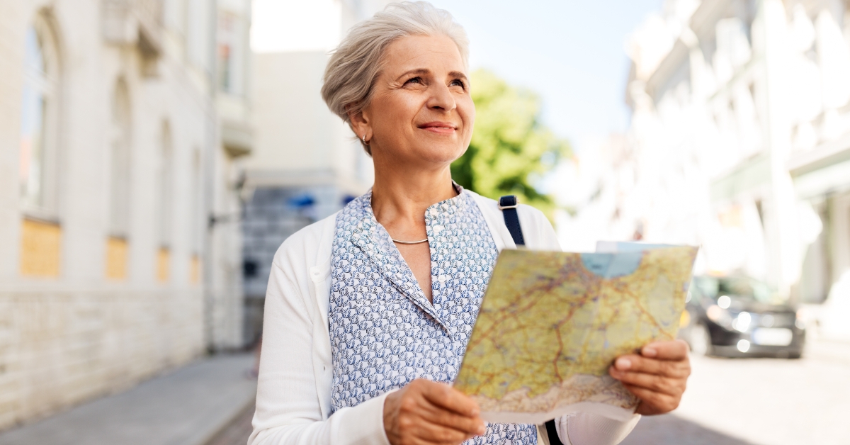 senior woman tourist with map on city street