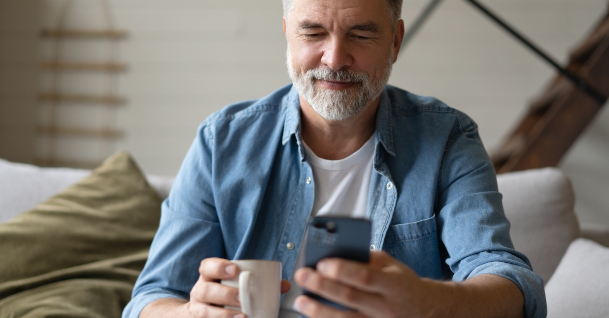 smiling senior man using smartphone
