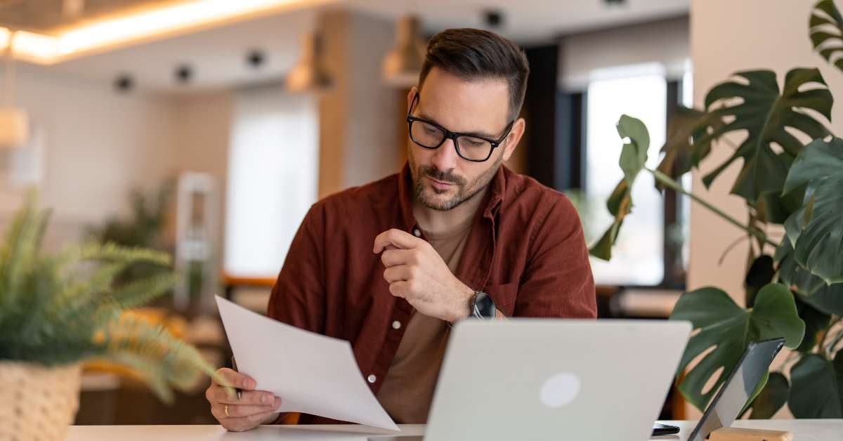 using laptop sitting at the table in a home
