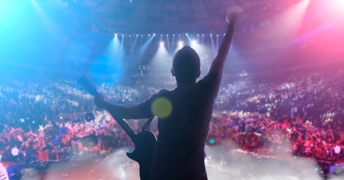 guy on stage with a guitar