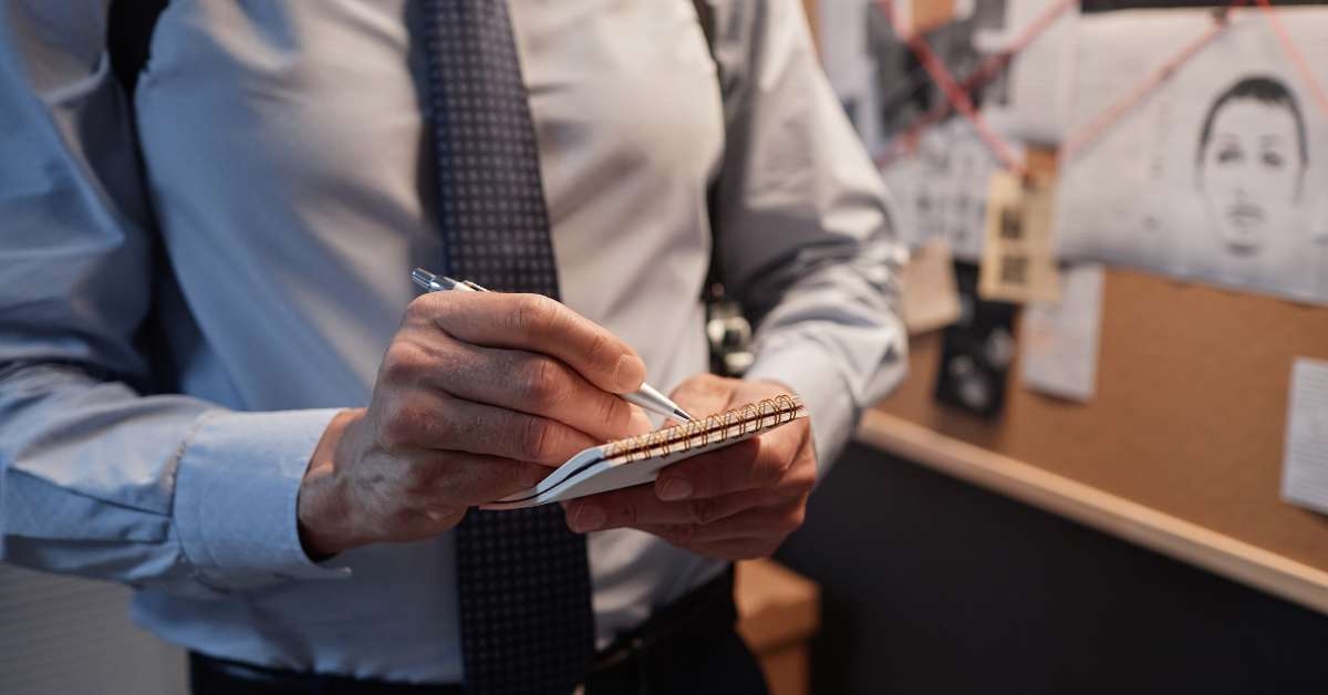 male detective taking notes