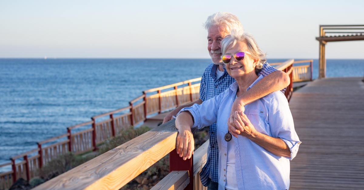 happy senior couple enjoying the view of the sea