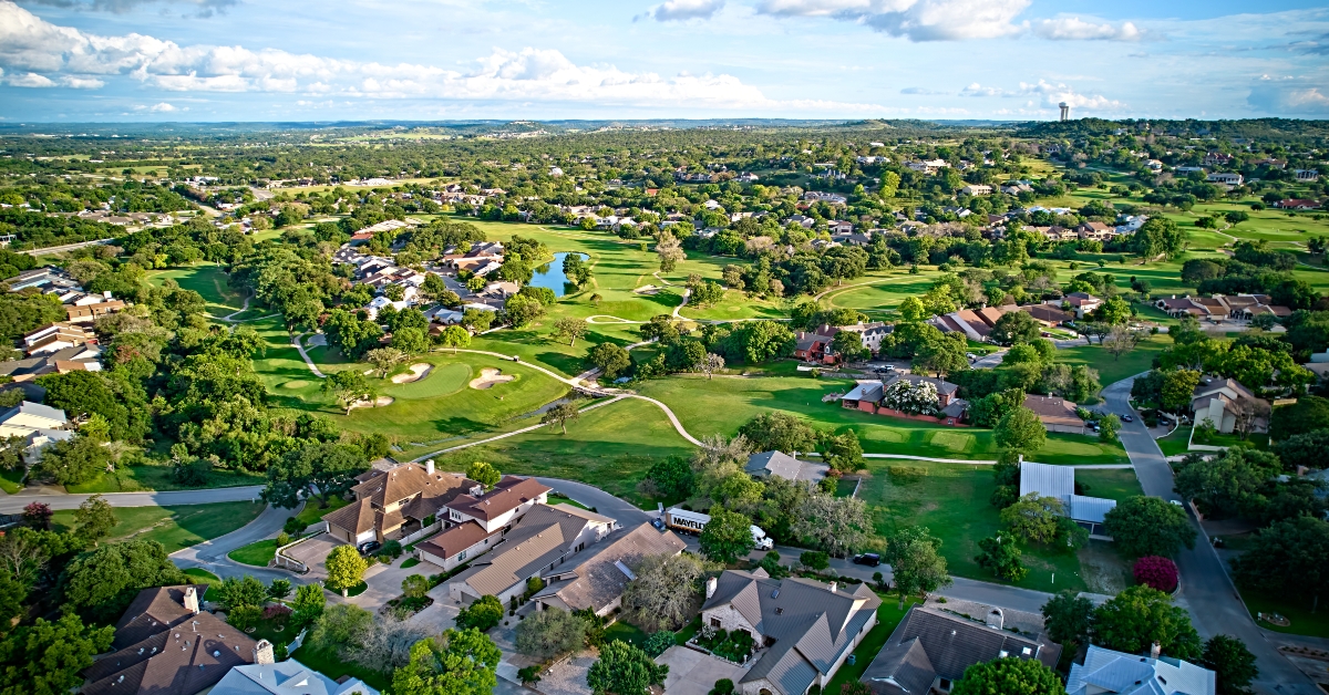 view of residential buildings and beautiful green fields