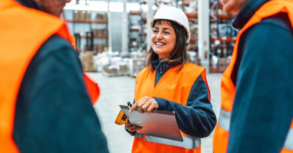 workers smiling and discussing logistics