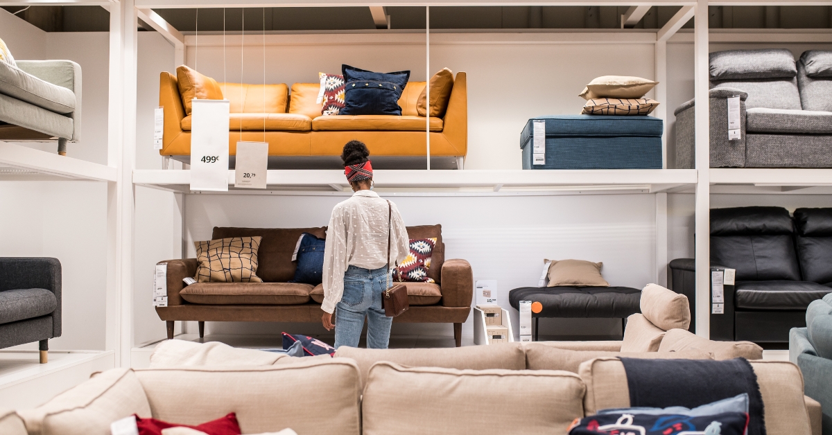 female customer choosing furniture in shopping center 
