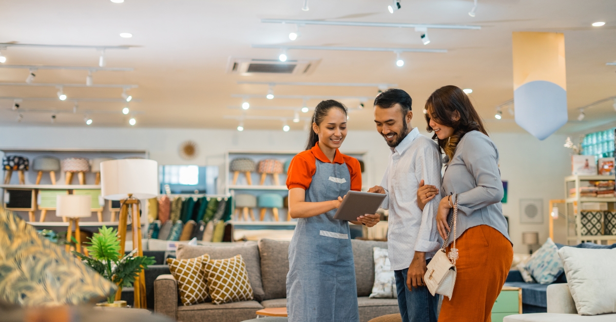shop assistant serving couple customer
