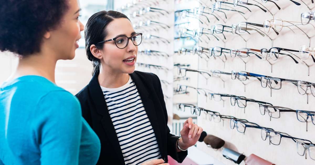 black woman inspecting glasses in optician