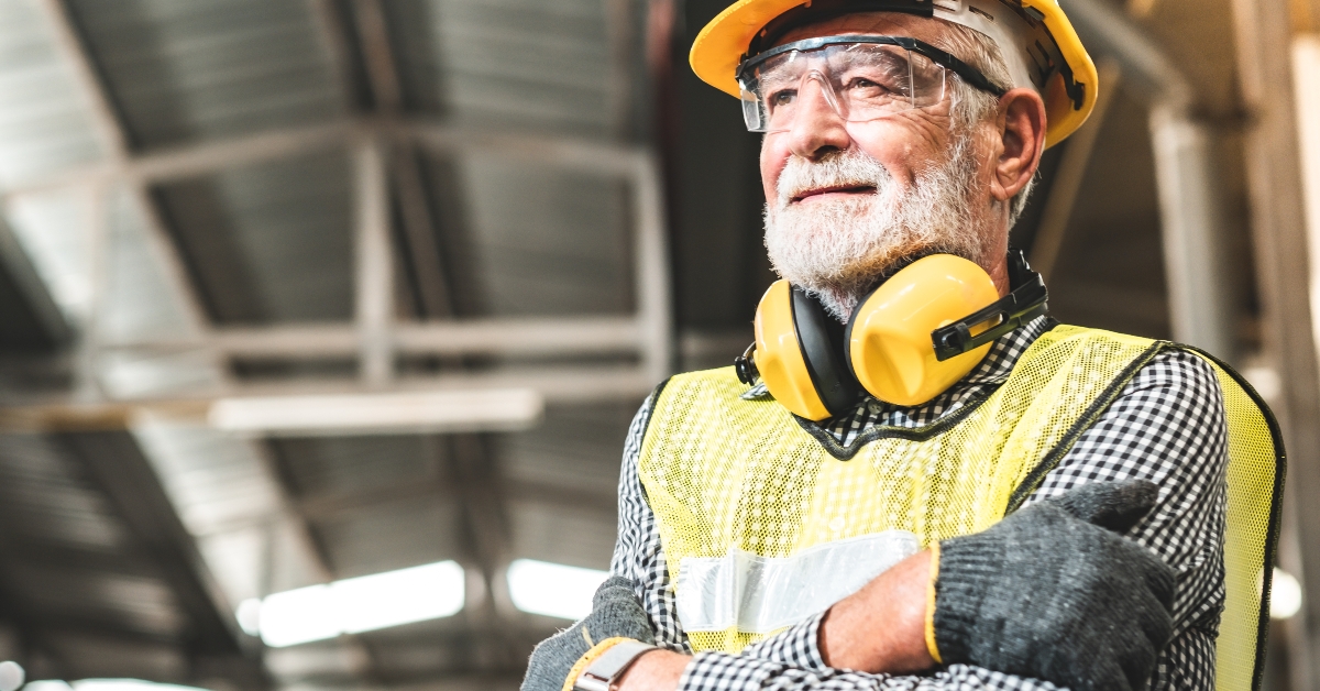 aged man working in an industrial factory