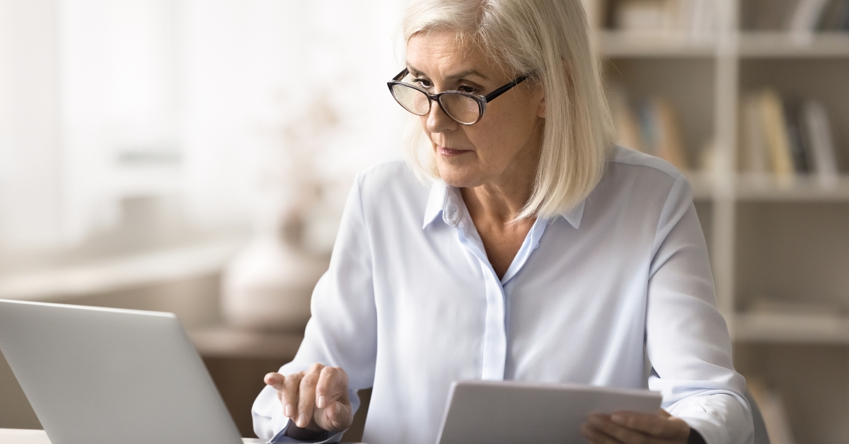 busy senior woman working at home