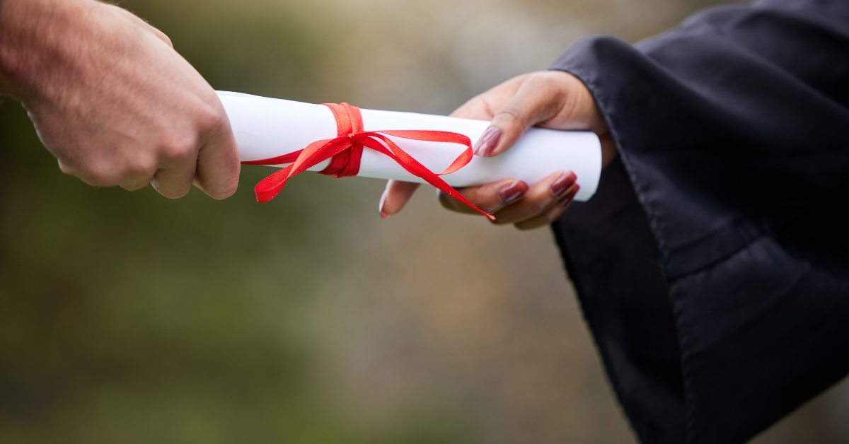 hands and giving diploma for graduation
