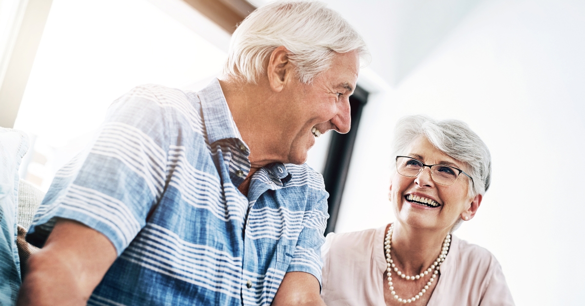 happy senior couple in home planning for retirement