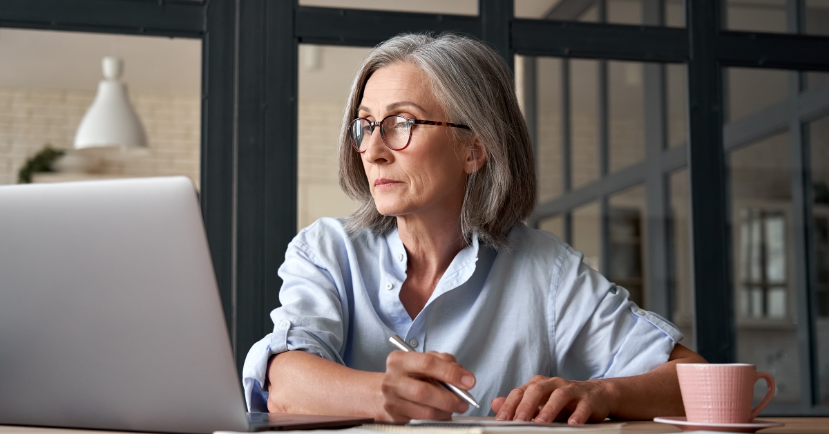 woman watching training webinar on laptop