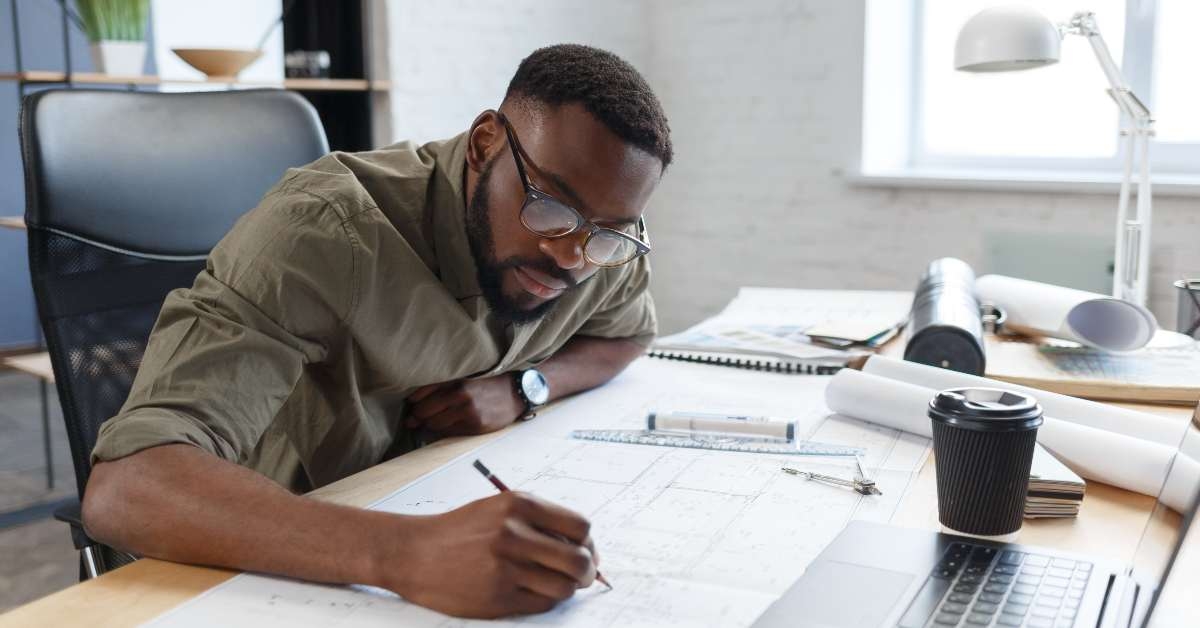 architect working in office with blueprints