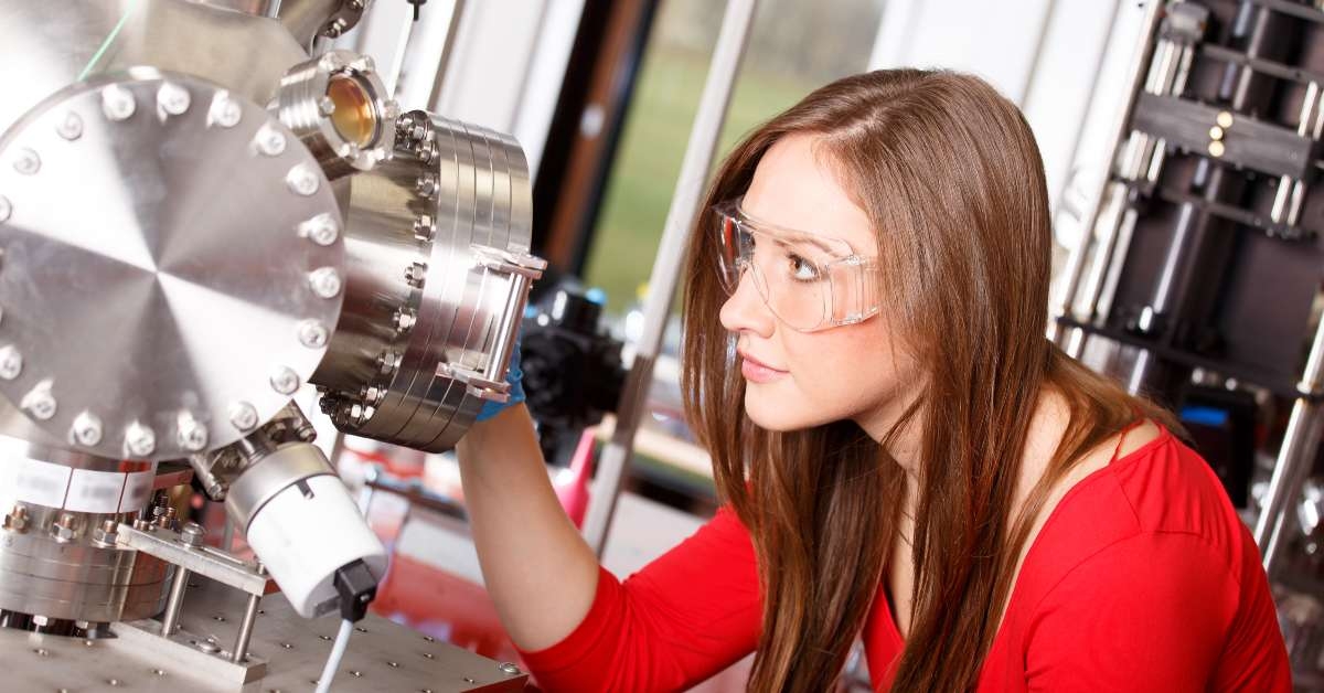 scientist looking to the laser deposition chamber