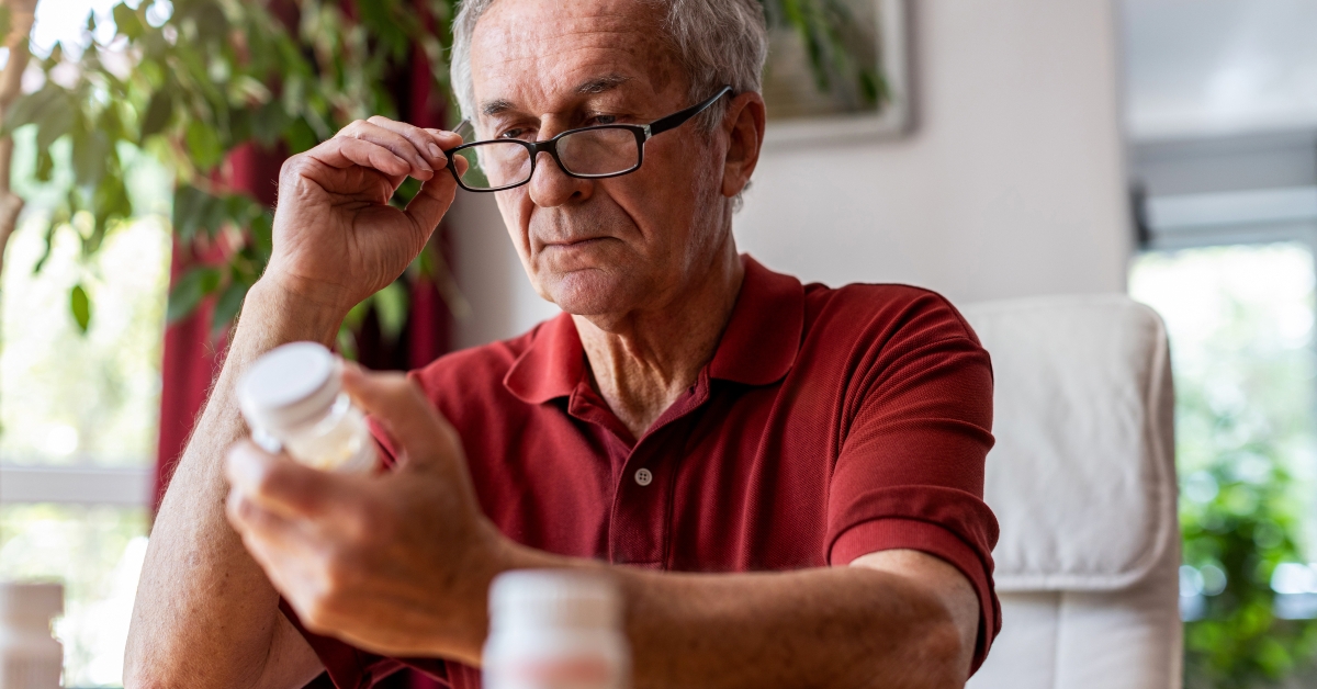 Senior man taking prescription medicine