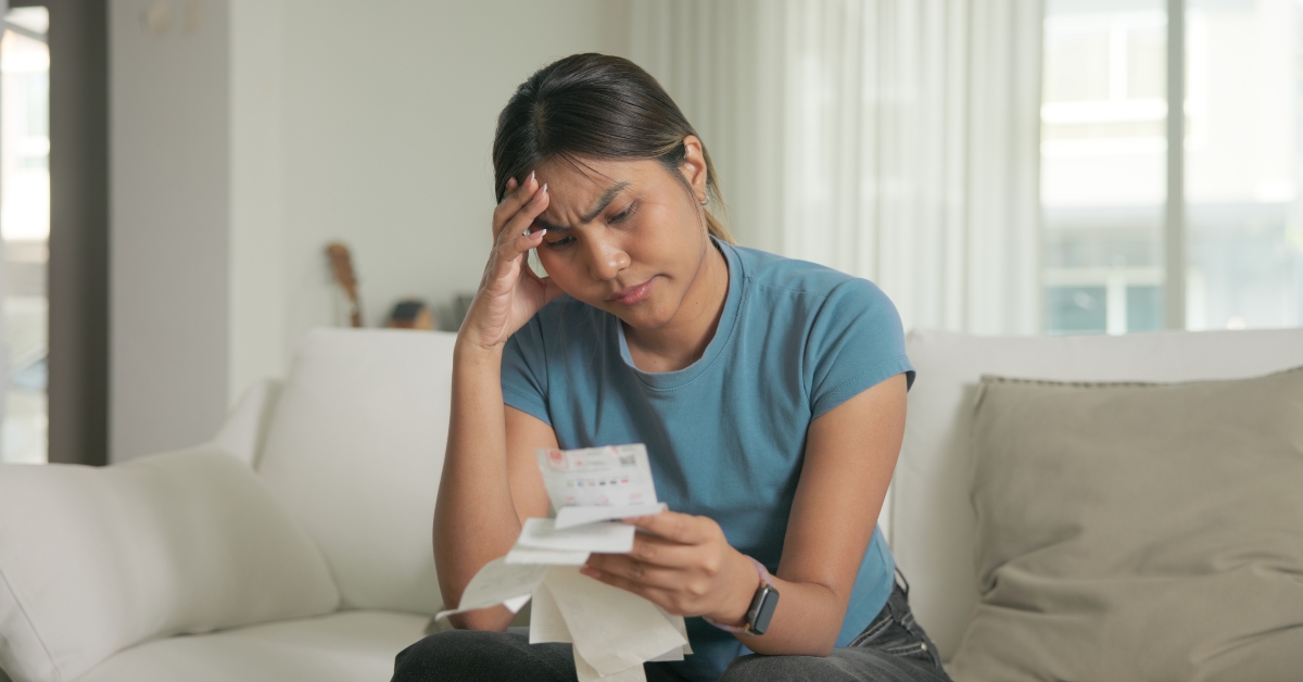 woman opening Past due credit card bill