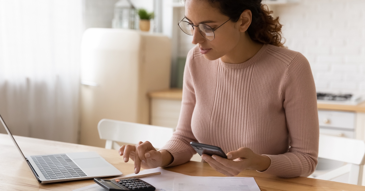 woman in eyeglasses managing monthly budget