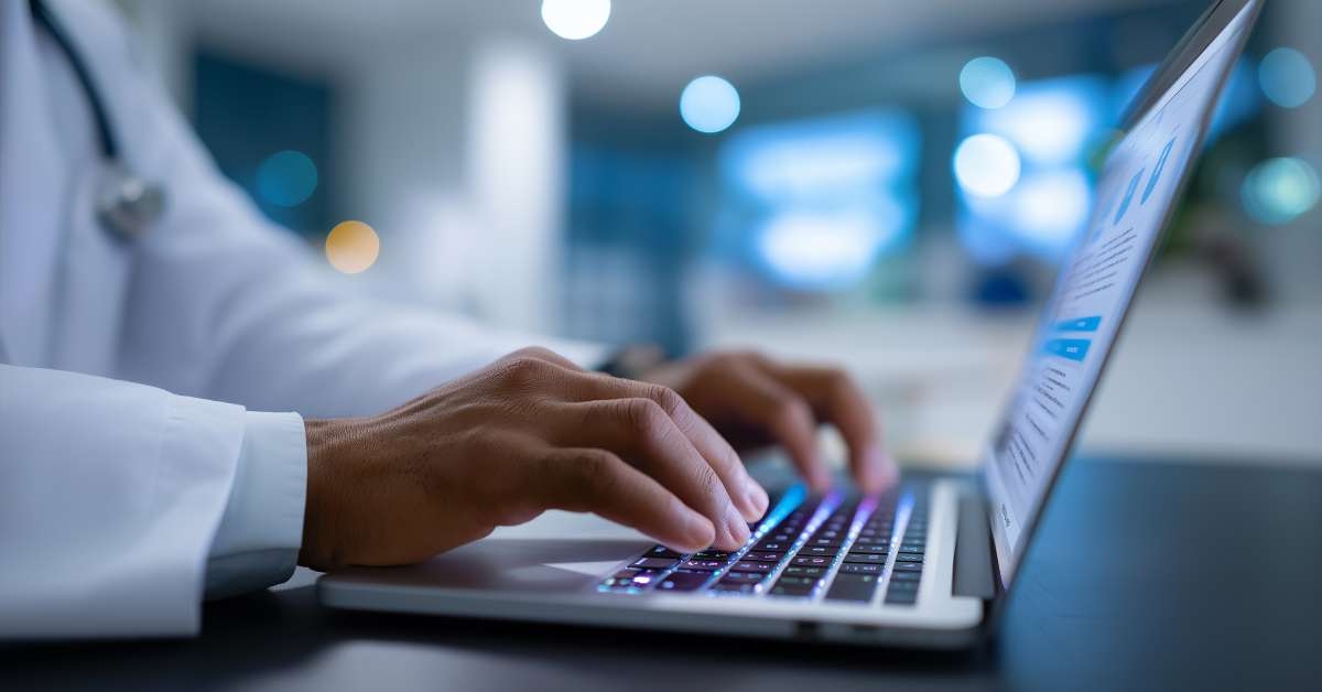 scientist typing on laptop